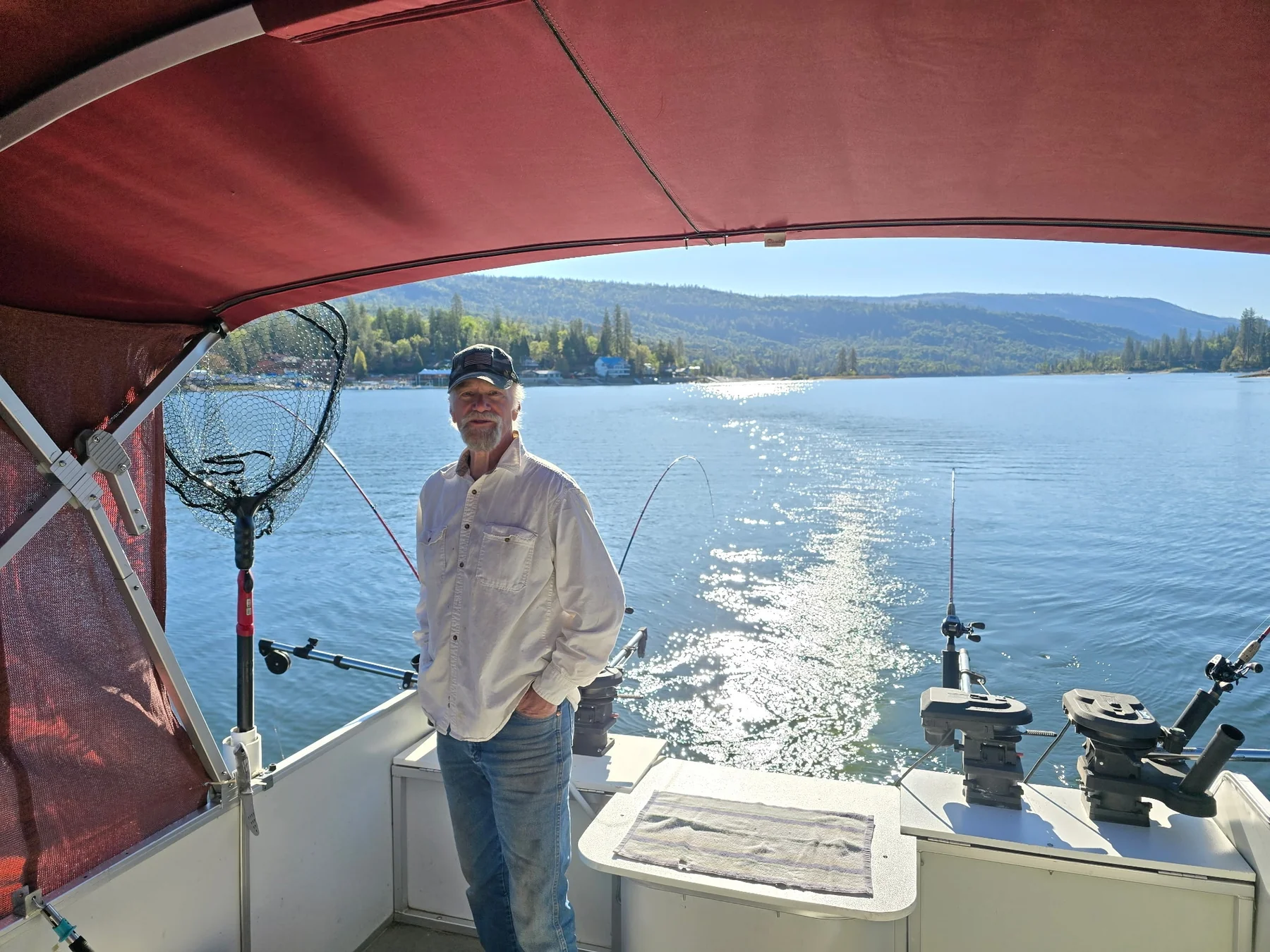 Mike Beighey aboard the Sun Tracker fishing barge on Bass Lake